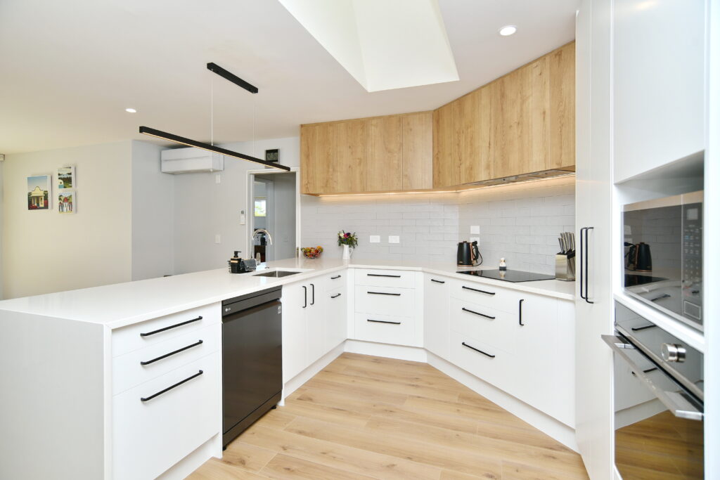 Timber flooring provides effective contrast with the white finish